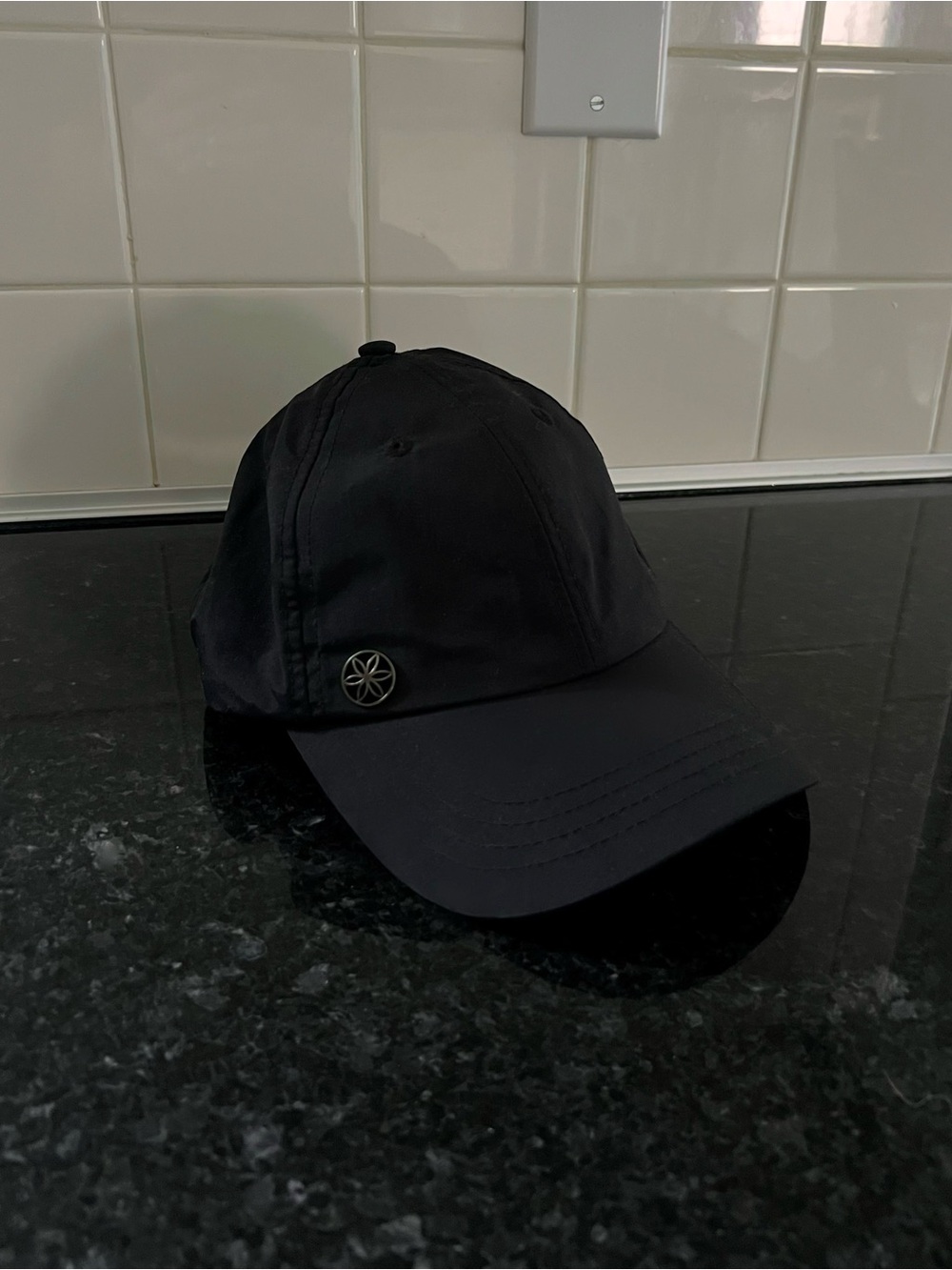 GAIAM Black Baseball Cap with Metal Emblem